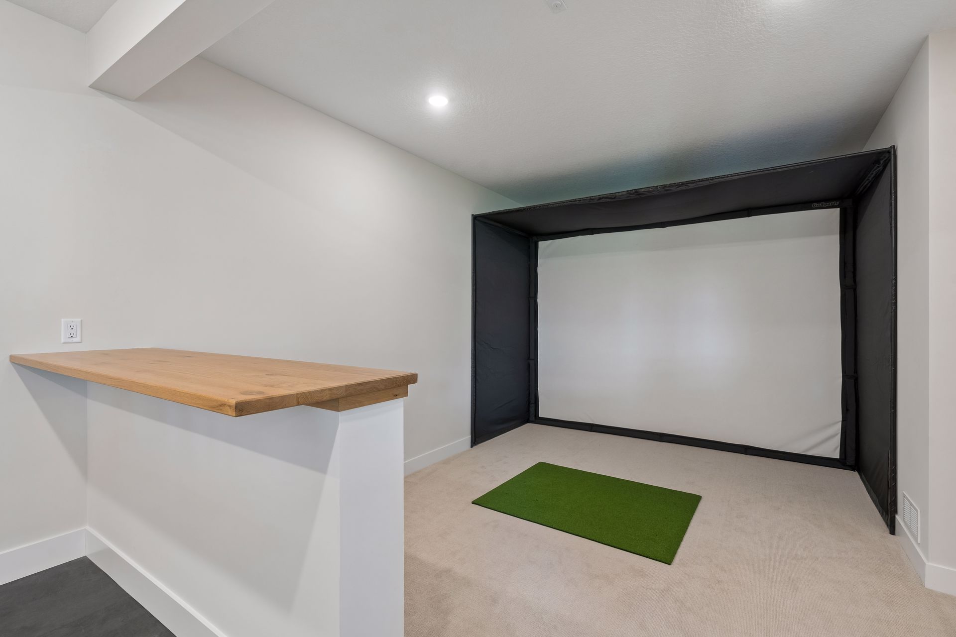 Indoor golf simulator room designed for year-round practice and entertainment